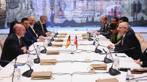 Europaminister Manfred Pentz sitzt mit Abgeordneten des Hessischen Landestages am Tisch und unterhält sich mit Akif Çağatay Kılıç